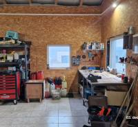 Workshop with tools and storage in a family house with wooden decor flooring.