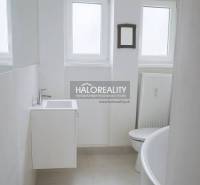 Bathroom in a 3-room apartment with a white sink, bathtub, and radiator.