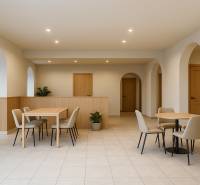 Gently lit commercial spaces with arches, furniture, and tiles, creating a pleasant environment.