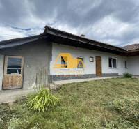 A family house in Svodín on Svodinská Street with a grassy front garden under a cloudy sky.