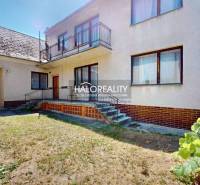 A family house in Malacky with a balcony, stairs, and a garden, accompanied by a shelter.