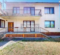A family house in Malacky with a balcony and a garage, surrounded by a garden.