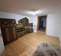 A room with a wooden decor floor, antique furniture, family house.