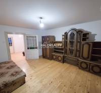 A room in a family house with furniture and a wooden decor floor.