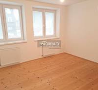 A room in a family house with a wooden decor floor and white walls.