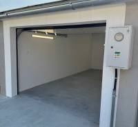 Garage with an opening on Slnečná Street in Komárno with a concrete floor and an electrical installation box.