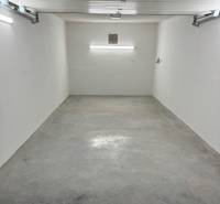 A spacious garage with white walls and a concrete floor in the Garage on Slnečná, Komárno.