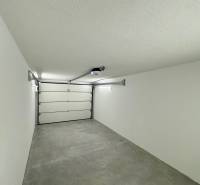 Garages with white walls and concrete floors on Slnečná Street in Komárno.