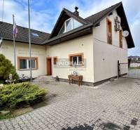 A family house in Prievidza with an asphalt yard, garden, and satellite dish.