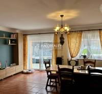 A dimly lit dining room in a family house with wooden floor decor.