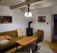 Living room of a family house with a stove, antique furniture, and decorations.