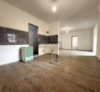 Interior of a family house with a wooden decor floor and tiles on the wall.