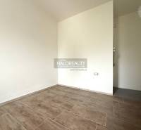 An empty room with a wood-patterned floor in a family house.