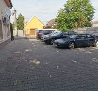 Parking lot on Šamorínska Street in Senec next to the offices, with cars including a sports car.