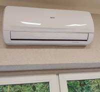 Air conditioning installed on the wall above the window in the office.