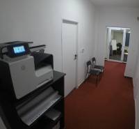 A corridor with a printer and chairs, entrance to the office on Šamorínska in Senec.