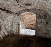 A basement in a family house with stone walls and a brick vaulted ceiling.