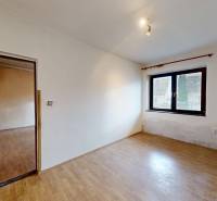A room with a wooden floor decor, a window, and a door in a family house.