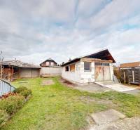 Garden with lawn and garage at a family house on SNP Street, Veľké Leváre.