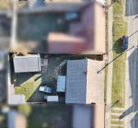 Aerial view of the roofs and gardens of family houses on SNP Street in Veľké Leváre.