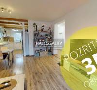 Living room and kitchen in a family house with a wooden decor floor.