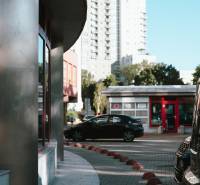 Záhradnícka Street in Bratislava with high-rise buildings and a parked car.