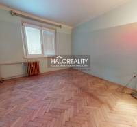 A room in a 3-room apartment with a wooden decor floor and a standing lamp.