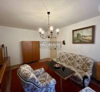 Living room in a 4-room apartment with classic furniture and an elegant chandelier.