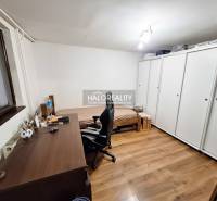 Office with a desk, chair, bed, and wardrobe in a family house.