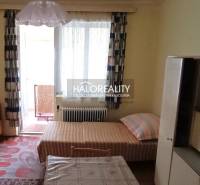 Interior of a room with older furniture and a bed, darkened window, family house.