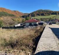 Plots - housing in Kľačno, with a view of picturesque autumn hills and village buildings.