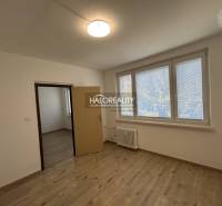 A room in a 3-room apartment with laminate flooring and a large window.