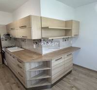 A kitchen with light wood and decor in a 3-room apartment.