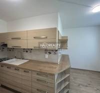A kitchen in a 3-room apartment with wooden cabinets and equipment.