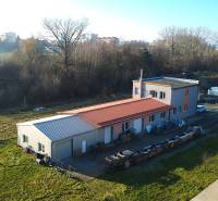 Production facilities on Továrenská Street in Dubnica nad Váhom, surrounded by greenery and buildings.