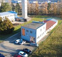 Production facilities on Továrenská Street in Dubnica nad Váhom, buildings surrounded by greenery.