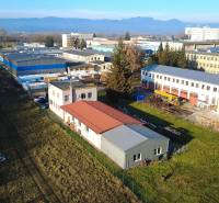 Production facilities on Továrenská Street in Dubnica nad Váhom, surrounded by extensive green areas.