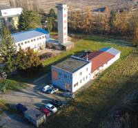 Production facilities on Továrenská Street in Dubnica nad Váhom surrounded by greenery and buildings.