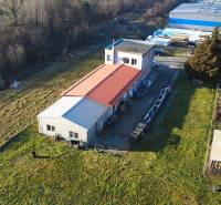 Production premises on Továrenská in Dubnica nad Váhom surrounded by greenery and other buildings.