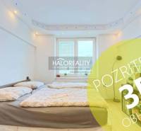 Bedroom in a 2-room apartment with a double bed and a large window.