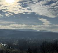 Panorama over Šahy with a background of hills and a cloudy sky.