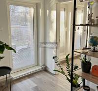 A room with glass doors to the garden and a floor with a wooden decor in a 4-room apartment.