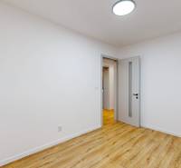 Interior of a family house with a wooden decor floor and white walls.
