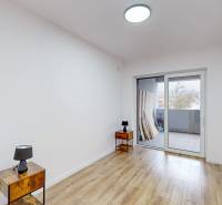 A room in a family house with a wooden decor floor and a balcony.