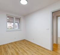 A spacious room with a wooden decor floor in a family house.