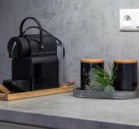 Coffee maker and decorations on the countertop in the vacation apartment.