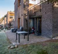 Stone facade and garden at the vacation apartment on Do doliny street in Liptovský Mikuláš.