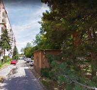 A view of Medzilaborecká Street in Bratislava - Ružinov with buildings and greenery.