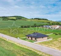 A family house in Štvrtok on Štvrtok Street surrounded by green fields and hills.