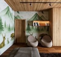 Interior with a wall mural of a forest, seating, and wood-patterned flooring for home construction.